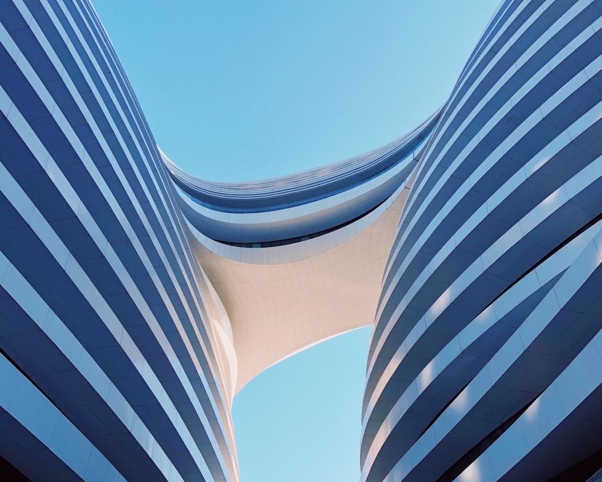 Curved modern commercial building facade against a clear sky