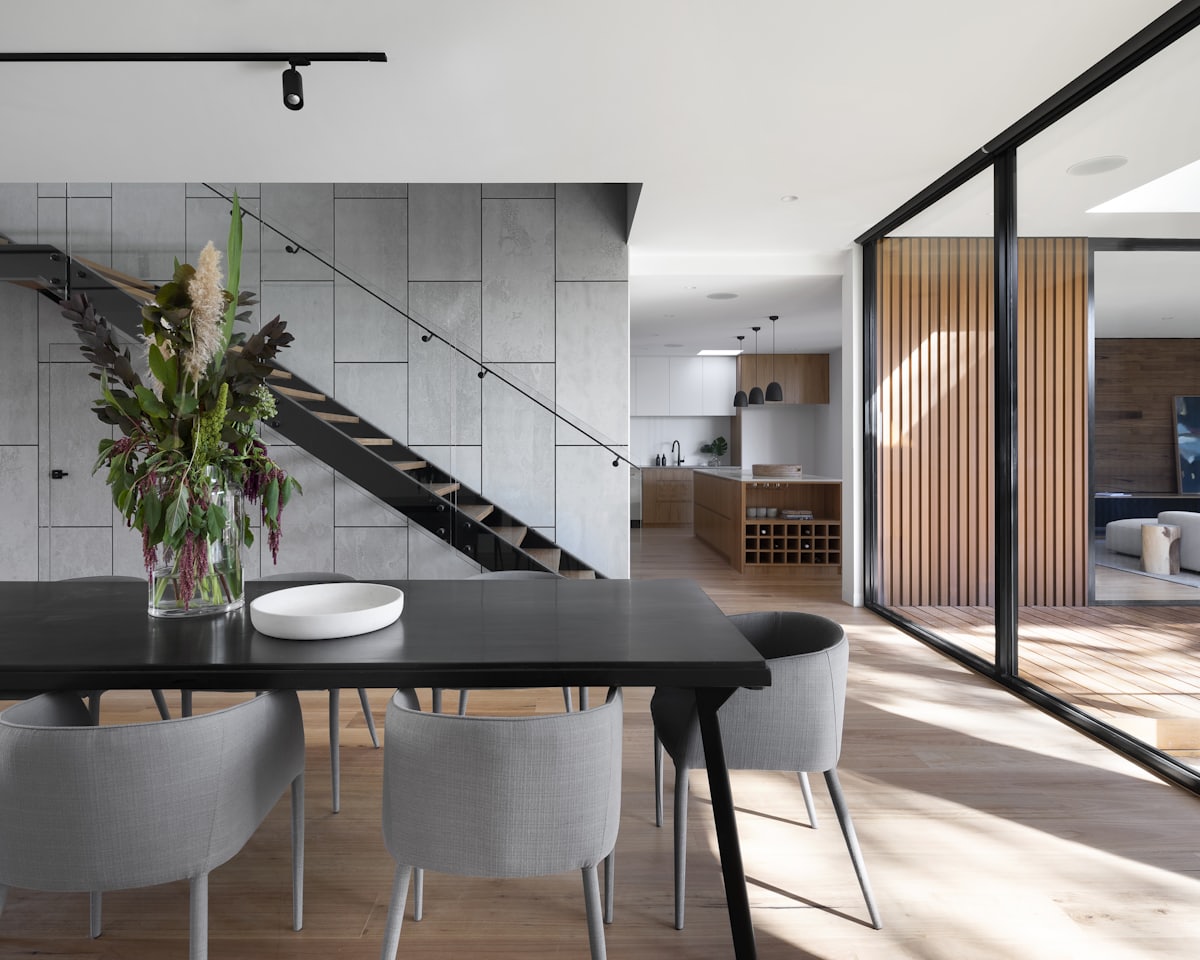 Elegant modern residence interior with an open staircase and dining area